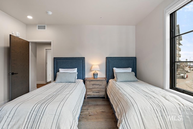 bedroom with dark wood-type flooring