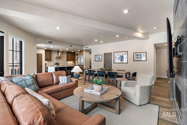 living room with sink and hardwood / wood-style flooring