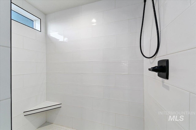 full bath featuring tiled shower