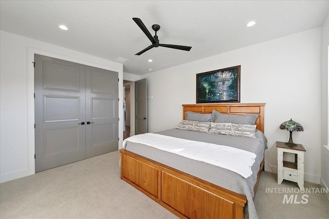 bedroom featuring a ceiling fan, recessed lighting, a closet, and light colored carpet