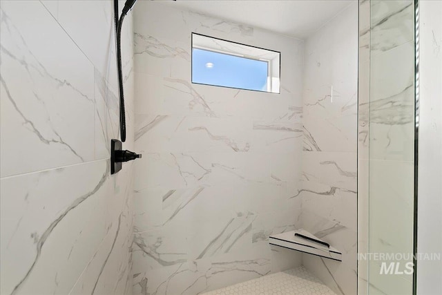 bathroom with a marble finish shower