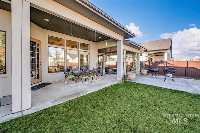 view of patio featuring area for grilling and fence