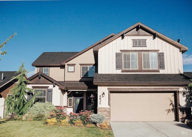 view of front of property with a garage and a front lawn