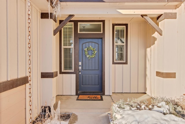 view of snow covered property entrance