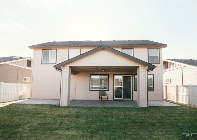 rear view of property with a lawn and a patio