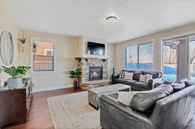 living room with a fireplace and dark wood-type flooring