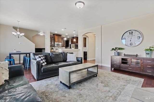 living room featuring a chandelier and dark hardwood / wood-style floors