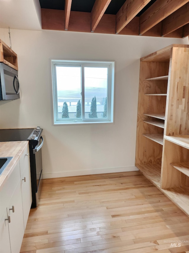 kitchen featuring electric range, baseboards, light wood-type flooring, white cabinetry, and open shelves