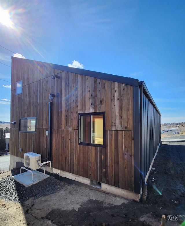 view of side of home featuring ac unit