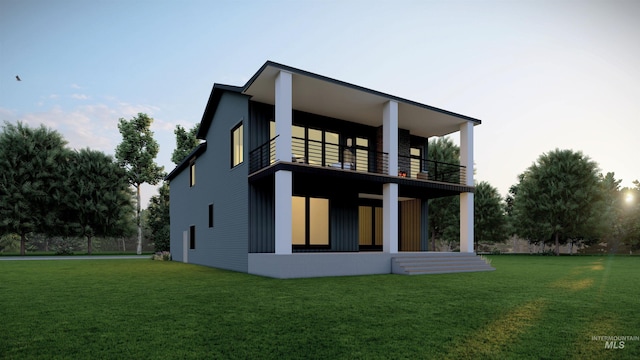 rear view of property with a yard, board and batten siding, and a balcony