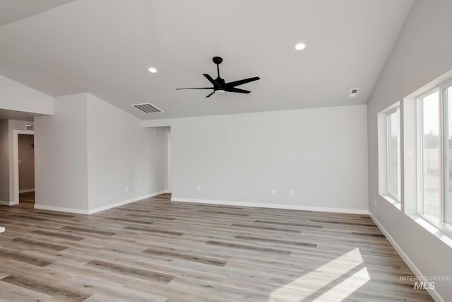 unfurnished room featuring plenty of natural light, visible vents, lofted ceiling, and a ceiling fan