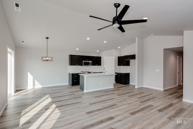 unfurnished living room with light wood-style flooring, recessed lighting, baseboards, visible vents, and ceiling fan with notable chandelier