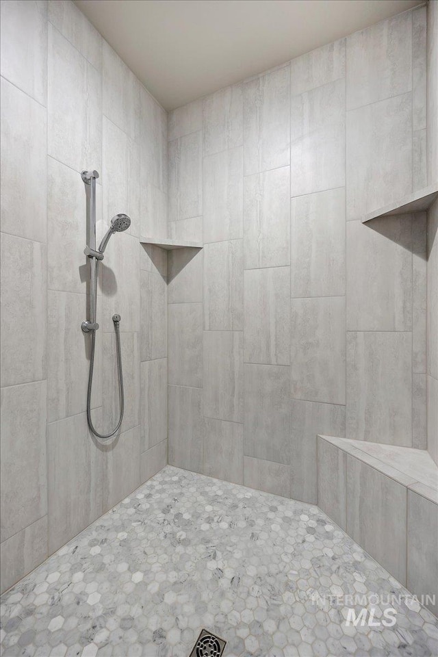 bathroom with a tile shower