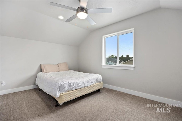 carpeted bedroom with ceiling fan and lofted ceiling