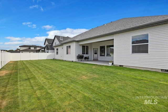 rear view of house with a patio area and a yard