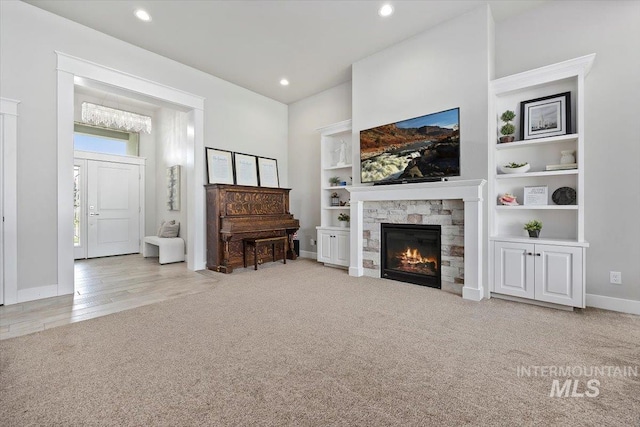 carpeted living room with a fireplace and built in shelves