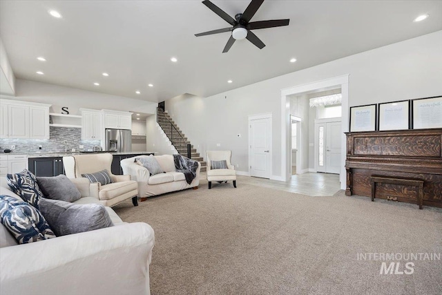 carpeted living room featuring ceiling fan