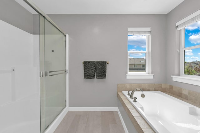 12041 W Ardyce, Boise, ID 83713 - full bath featuring a garden tub, a stall shower, wood finished floors, and baseboards
