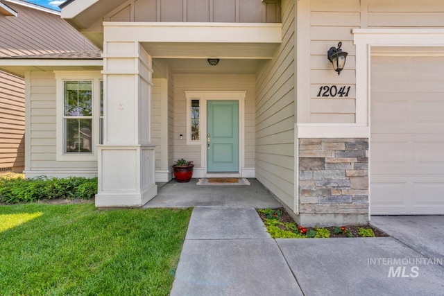 12041 W Ardyce, Boise, ID 83713 - entrance to property featuring board and batten siding, an attached garage, stone siding, and metal roof