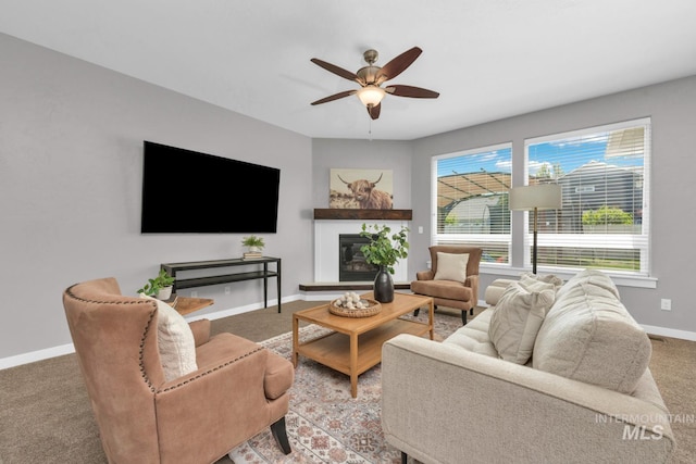 12041 W Ardyce, Boise, ID 83713 - carpeted living area featuring baseboards, a glass covered fireplace, and a ceiling fan