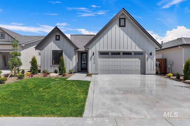 modern farmhouse with a front yard and a garage