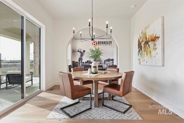 dining room featuring light hardwood / wood-style flooring and an inviting chandelier