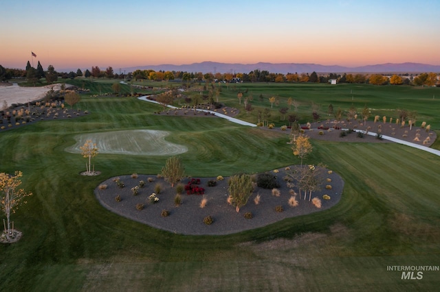 aerial view at dusk featuring a mountain view