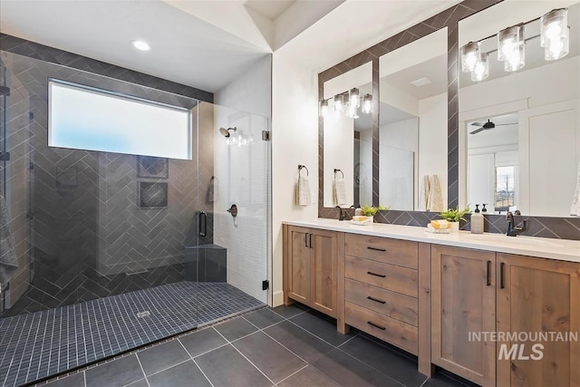 bathroom featuring tile patterned flooring, vanity, an enclosed shower, and ceiling fan