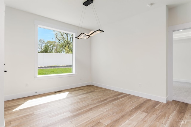 unfurnished dining area with light wood-type flooring