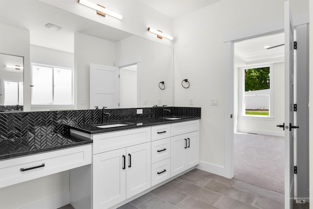 bathroom featuring vanity, tile patterned flooring, and backsplash