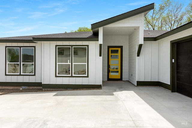 view of exterior entry featuring a patio area