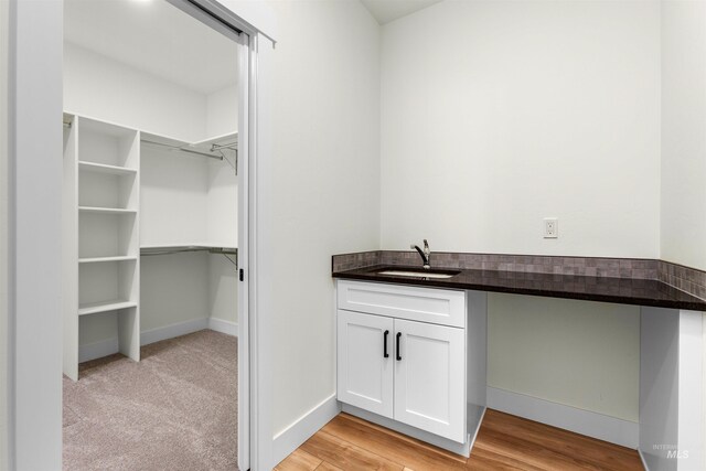 interior space with sink and light colored carpet