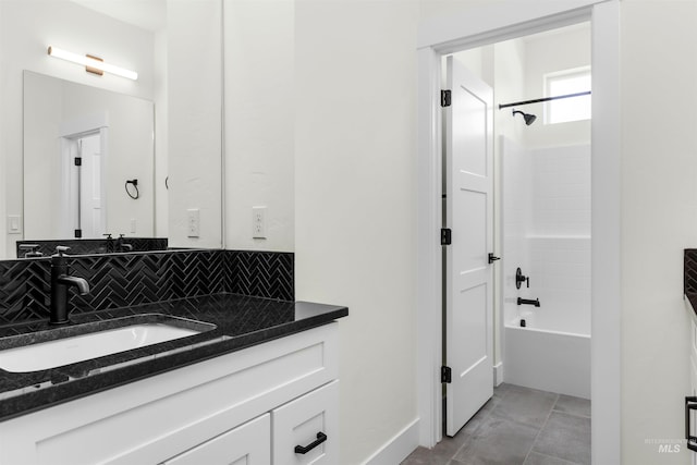 bathroom with shower / washtub combination, vanity, and decorative backsplash