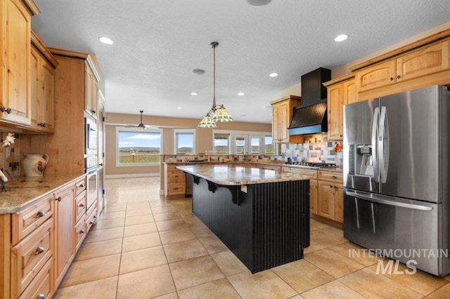 2600 W S Slope Rd, Emmett, ID 83617 - kitchen with appliances with stainless steel finishes, a peninsula, tasteful backsplash, recessed lighting, and light stone counters