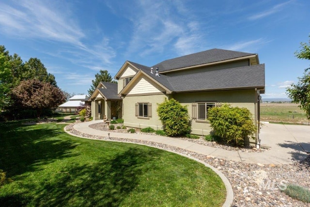 2600 W S Slope Rd, Emmett, ID 83617 - rear view of house with a yard, stucco siding, and a shingled roof