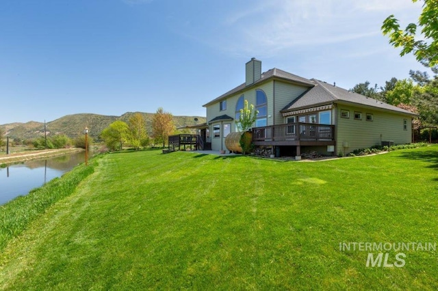 2600 W S Slope Rd, Emmett, ID 83617 - back of house featuring a deck with water view, a yard, and a chimney