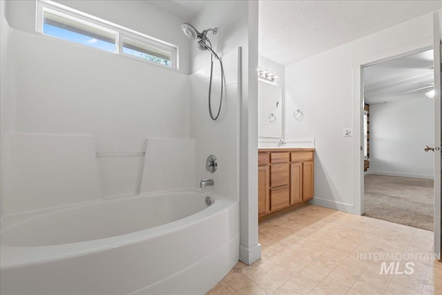 6311 S Solar Way, Boise, ID 83709 - full bath featuring vanity, bathing tub / shower combination, baseboards, and tile patterned flooring