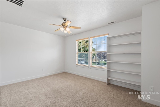 6311 S Solar Way, Boise, ID 83709 - unfurnished room with carpet floors, ceiling fan, baseboards, and a textured ceiling
