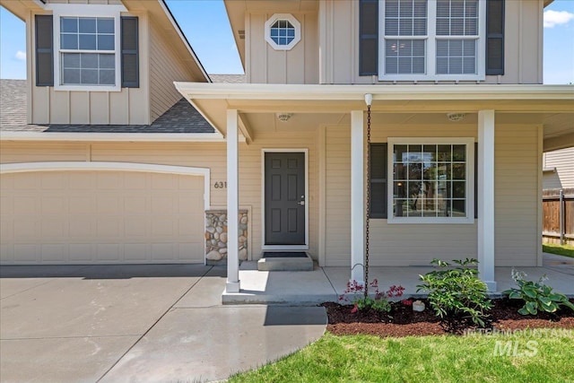 6311 S Solar Way, Boise, ID 83709 - property entrance featuring board and batten siding, concrete driveway, a porch, and roof with shingles