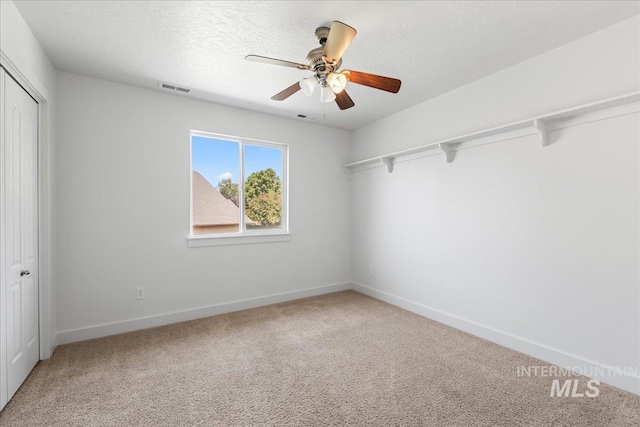 6311 S Solar Way, Boise, ID 83709 - unfurnished bedroom with carpet, a closet, baseboards, a ceiling fan, and a textured ceiling