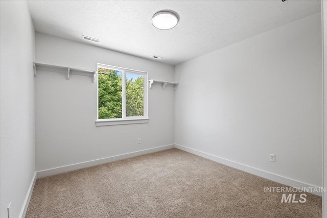 6311 S Solar Way, Boise, ID 83709 - spare room with carpet floors, baseboards, and a textured ceiling
