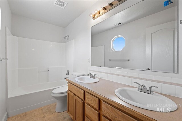 6311 S Solar Way, Boise, ID 83709 - bathroom featuring toilet, double vanity, shower / bath combination, and decorative backsplash