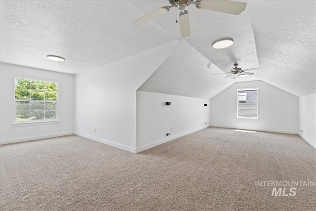6311 S Solar Way, Boise, ID 83709 - additional living space featuring a textured ceiling, a ceiling fan, carpet floors, baseboards, and lofted ceiling