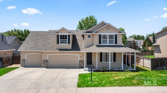 6311 S Solar Way, Boise, ID 83709 - view of front of house with concrete driveway, a porch, an attached garage, board and batten siding, and stone siding