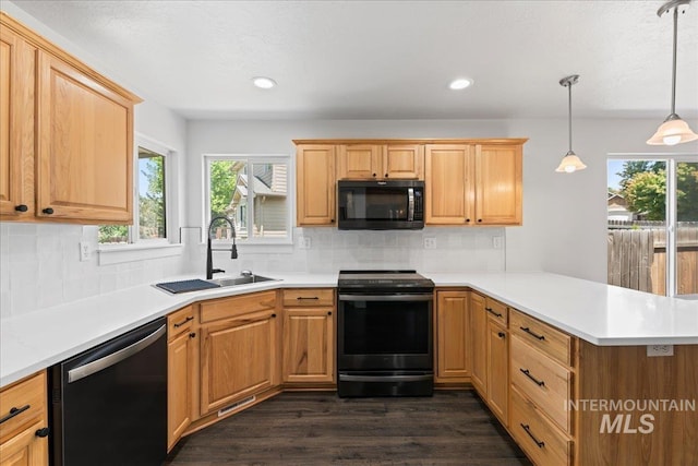 6311 S Solar Way, Boise, ID 83709 - kitchen with black microwave, range with electric cooktop, stainless steel dishwasher, a sink, and a peninsula