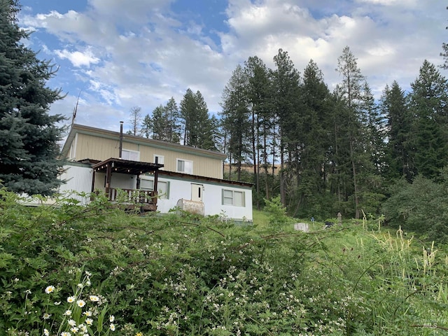 back of property featuring a pergola