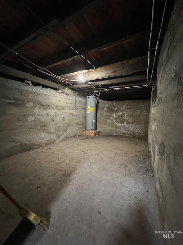 unfinished below grade area featuring water heater