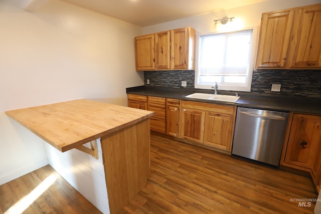 kitchen with a kitchen breakfast bar, tasteful backsplash, stainless steel dishwasher, dark wood-type flooring, and sink