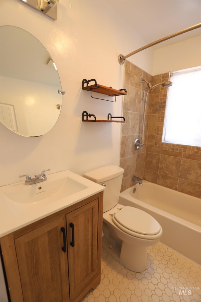 full bathroom featuring tile patterned floors, vanity, toilet, and tiled shower / bath