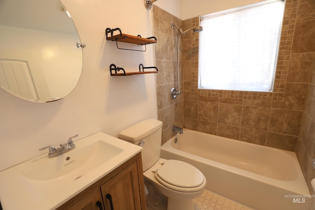full bathroom featuring vanity, tiled shower / bath combo, and toilet